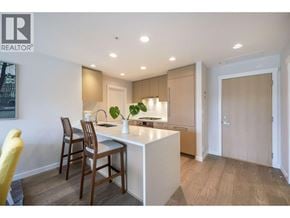 Vancouver apartment for rent - A modern kitchen with a dining table and chairs.