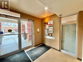 Clarington (Bowmanville) condo for rent - A hallway with a glass door leading to a balcony.