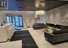 Barrie (Little Lake) condo for rent - A realtor brokerage office with a reception desk and a couch.