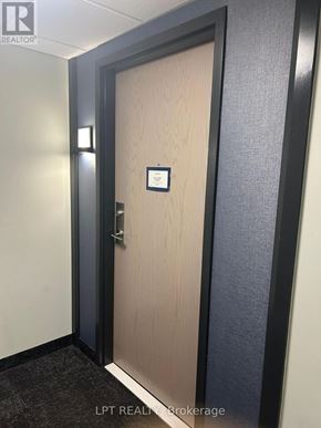 Barrie (Little Lake) condo for rent - A door with a sign on it in a hallway.