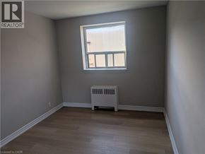 Hamilton condo for rent - A room with a window and a radiator on the floor.