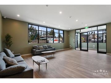 Surrey apartment for rent - A living room with a grey couch and a coffee table.