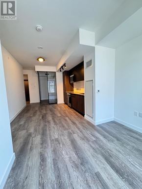 Toronto (Centennial Scarborough) condo for rent - A spacious room with a grey floor and white walls.