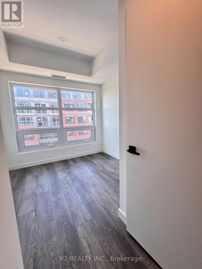Toronto (Centennial Scarborough) condo for rent - A room with a window showing a view of a building outside.
