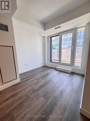 Toronto (Centennial Scarborough) condo for rent - A room with a window and a wooden floor.