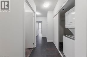 Burlington condo for rent - A long hallway with a kitchen area on the right.