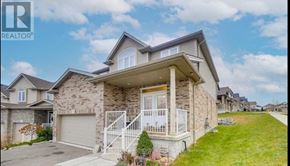 Waterloo apartment for rent - A house with a stone facade and a white garage door is for sale.