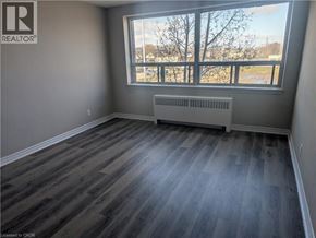 Hamilton condo for rent - A room with a window and a radiator on the floor.