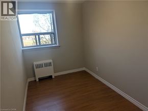Hamilton condo for rent - A room with a window and a heater.