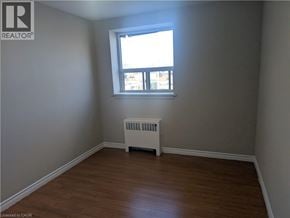 Hamilton condo for rent - A room with a window and a radiator on the floor.