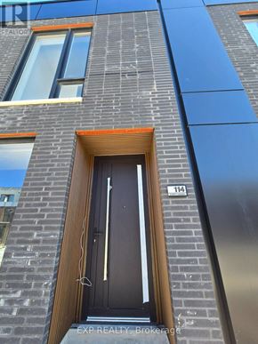 St. Catharines (Oakdale) townhouse for rent - A modern building with a black door and windows.