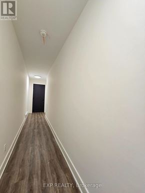 St. Catharines (Oakdale) townhouse for rent - A long hallway with wood floors and white walls.