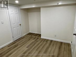 Newmarket (Huron Heights-Leslie Valley) apartment for rent - A room with wooden flooring and white walls.