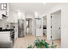 Vancouver apartment for rent - A modern kitchen with white cabinets and a stainless steel refrigerator.