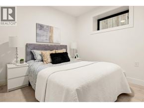 Vancouver apartment for rent - A bedroom with a large bed and a painting on the wall.