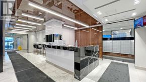 Toronto (Henry Farm) condo for rent - A modern office lobby with a reception desk and a large screen on the wall.