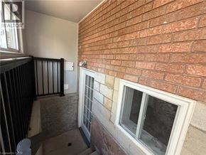 Stoney Creek apartment for rent - A balcony with a brick wall and a window.