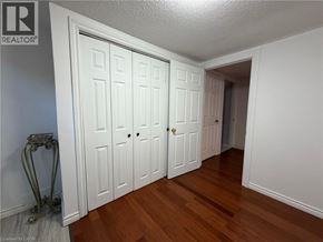 Stoney Creek apartment for rent - A room with white doors and a wooden floor.