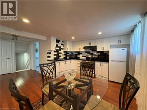 Stoney Creek apartment for rent - A kitchen with a table and chairs in the foreground.