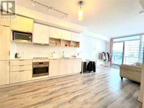 Toronto (Henry Farm) condo for rent - A well-lit kitchen with wooden floors and white cabinets.