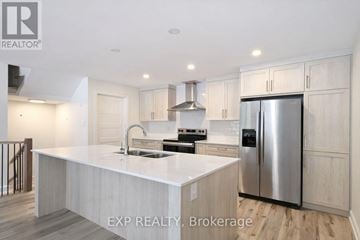 Russell townhouse for rent - A modern kitchen with a stainless steel refrigerator and a center island.