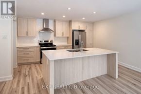Russell townhouse for rent - A kitchen with a white countertop and wooden cabinets.