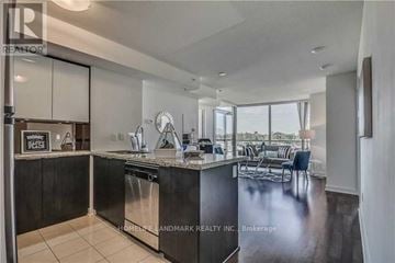 Toronto (Newtonbrook West) condo for rent - A modern kitchen with a large island and a dining area.