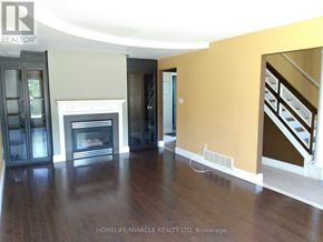 Hamilton (Gourley) apartment for rent - A living room with a fireplace and a staircase.