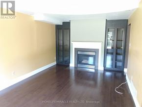 Hamilton (Gourley) apartment for rent - A room with a fireplace and wooden floors.
