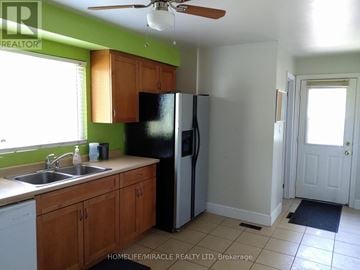 Hamilton (Gourley) apartment for rent - A kitchen with a sink, refrigerator, and cabinets.