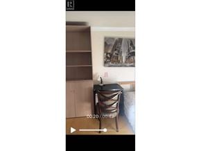 Vancouver apartment for rent - A black chair with a woven seat and back is in the foreground of a video.