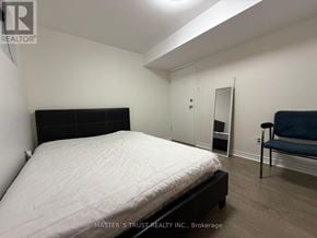 Toronto (Tam O'shanter-Sullivan) apartment for rent - A bedroom with a bed, chair, and closet.