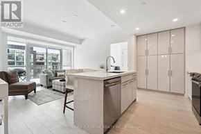 Innisfil condo for rent - A modern kitchen with a large island and stainless steel appliances.