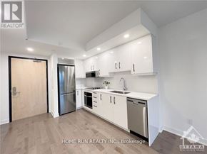 Ottawa condo for rent - A kitchen with white cabinets and stainless steel appliances.