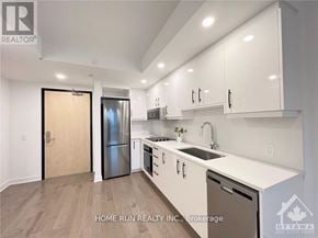Ottawa condo for rent - A modern kitchen with white cabinets and a wooden door.