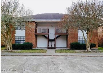 Lafayette apartment for rent - A two-story brick building with a balcony on the second floor.