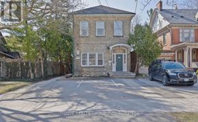 London East (East F) fourplex for rent - A house with a car parked in front of it.