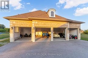 Whitchurch-Stouffville (Ballantrae) apartment for rent - A house with a garage and a sign that says "ON THE BLOCK, Brokerage".