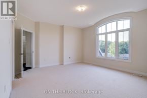 Whitchurch-Stouffville (Ballantrae) apartment for rent - A spacious room with a large window and a door leading to another room.