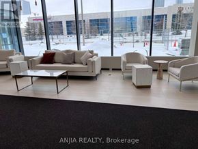 Vaughan (Vaughan Corporate Centre) condo for rent - A view of a waiting area with a large window showing the outside.
