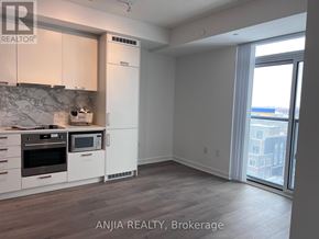 Vaughan (Vaughan Corporate Centre) condo for rent - A kitchen with white cabinets and a marble backsplash is shown in the image.