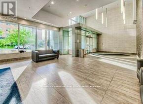 Waterloo condo for rent - A spacious living room with a couch, a staircase, and a glass wall.