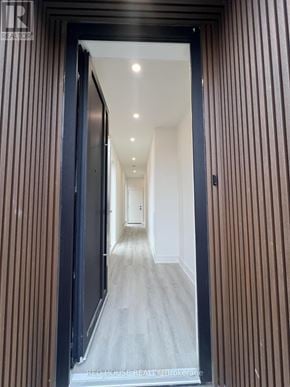 St. Catharines (Oakdale) townhouse for rent - A hallway with a black door and striped walls.