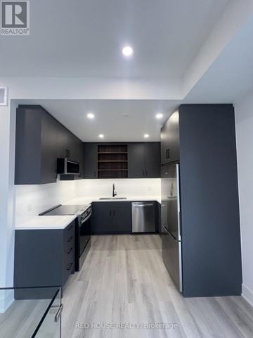 St. Catharines (Oakdale) townhouse for rent - A modern kitchen with dark grey cabinets and a central island.