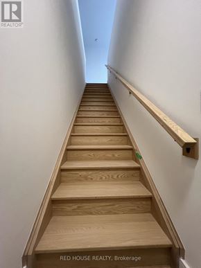St. Catharines (Oakdale) townhouse for rent - A set of wooden stairs with a handrail on the side.