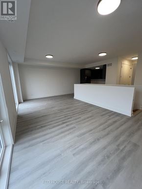 St. Catharines (Oakdale) townhouse for rent - A spacious room with a white wall and a grey floor.
