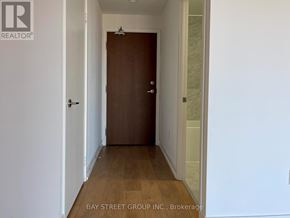 Toronto (Bayview Village) condo for rent - A hallway with a brown door and white walls.