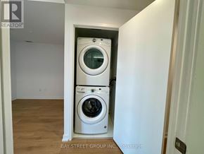 Toronto (Bayview Village) condo for rent - A white washer and dryer in a small laundry room.