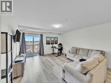 Windsor condo for rent - A living room with a grey couch and a television.