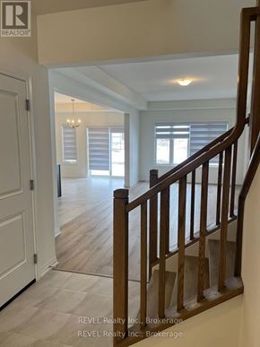 Pelham (Fonthill) apartment for rent - A staircase in a home with a white door and a window with blinds.